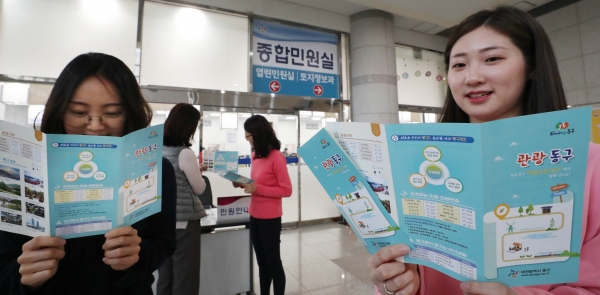 동구청 열린민원실 직원들이 ‘관광동구’ 리플릿을 살펴보고 있다
