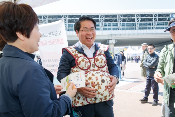 오세현 아산시장이 ‘혼자하면 힘든 육아, 함께하면 든든 육아’ 부스에 참여, 임산부 체험복을 착용해보고 있다.