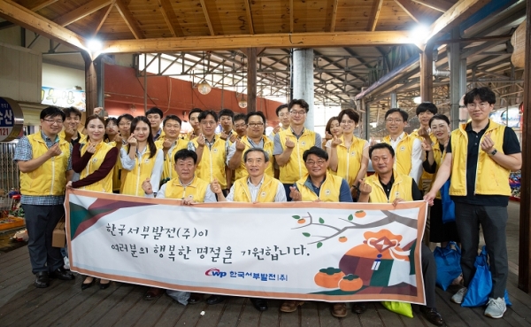 한국서부발전 김병숙 사장(앞줄 왼쪽 2번째), 송재섭 기획관리본부장(왼쪽 1번째), 유승재 노조위원장(왼쪽 3번째) 등 서부발전의 노사 관계자들이 전통시장에서 물품구매 후 기념촬영