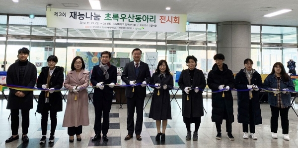 황지현교수(좌3),정기철 공학박사(좌4), 김태봉총장(좌5), 박미애본부장(좌6), 김화순센터장(좌7) 및 초록우산 동아리 학생들이 재능 나눔 전시회 테이프 컷팅식을 진행하고 있다.