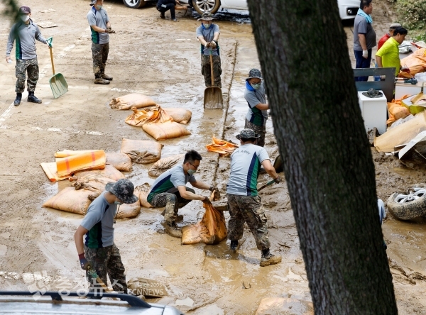 Militaries, who came to support the people, pours soil into bags at flood-stricken apartments in Jeongnim-dong, Seo-gu, Daejeon. / Photo by Minyeong Jo from Chungcheong News