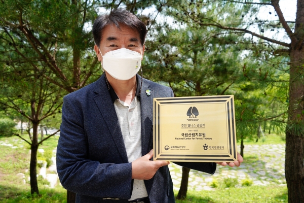 김종연 국립산림치유원장이 14일 경북 영주시 봉현면 산림치유원에서 추천 웰니스 관광지 인증패를 들고 기념사진을 촬영하고 있다
