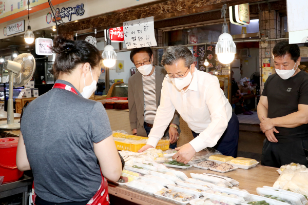 6일 송강전통시장을 방문한 정용래 유성구청장(가운데)이 상인들의 어려움 청취 모습