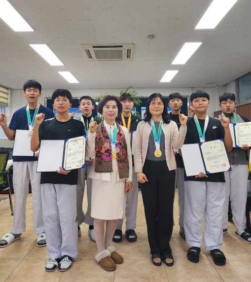 오정중 태권도선수들 및 교장 임은영(왼쪽2번째),교감 윤명선(왼쪽3번째)